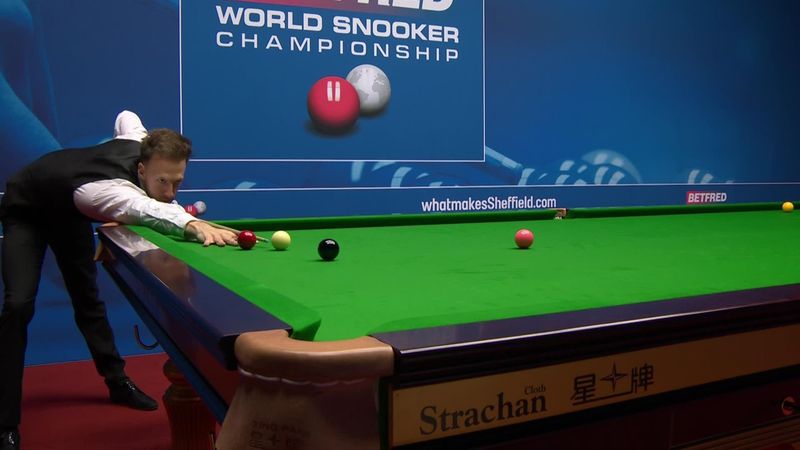 Judd Trump plays three exhibition shots, one right-handed at World Championship